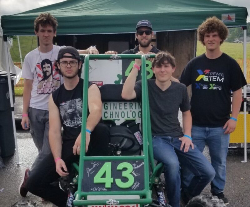 Baja racing team students and their faculty advisor