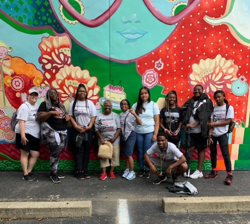 Upward Bound students in front of ArtWorks mural