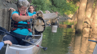 Students in canoes collecting water samples