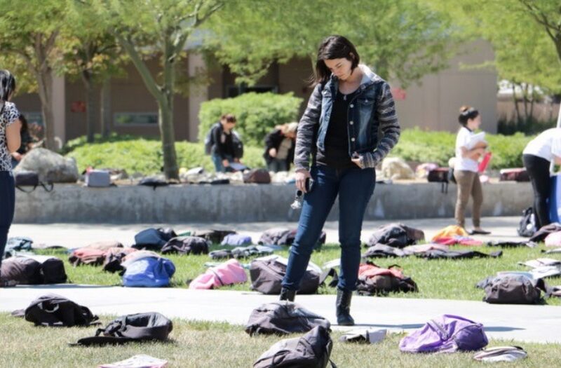 woman viewing display of backpacks