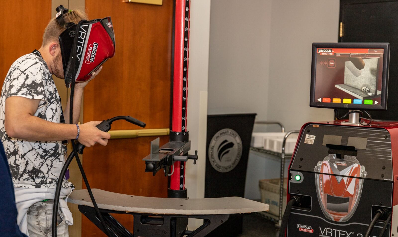 Student uses welding equipment at ENGAGE: Students