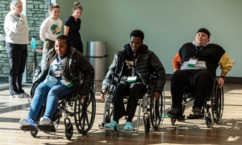 Students in wheelchair race at ENGAGE