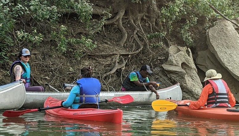 Students in canoes collecting water samples