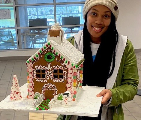 Amisha Walton with her gingerbread house