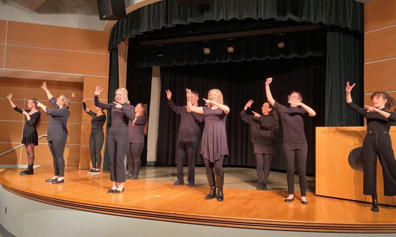 Group of students performing American Sign Language