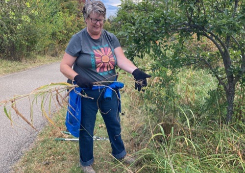 Student cuts down invasive plants