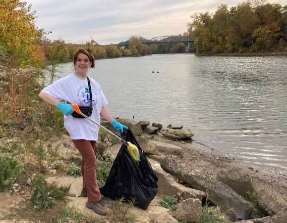 Student cleaning up near the Ohio Riber bank