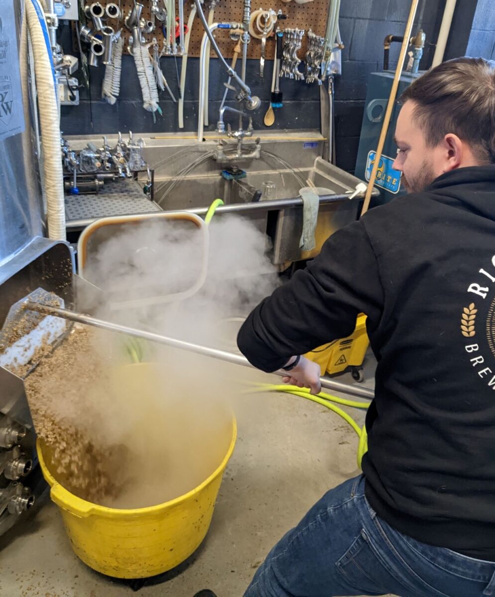 Brewing student Ryan Frost help the  brewing process