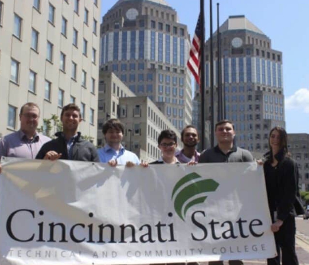 Students holding Cincinnati State banner in front of Procter & Gamble headquarters