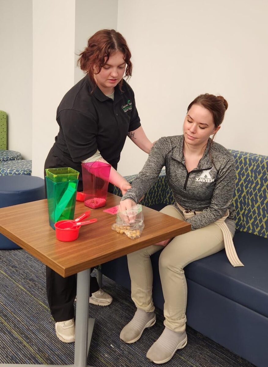 Cincinnati State student and Xavier student working together on occupational therapy skills