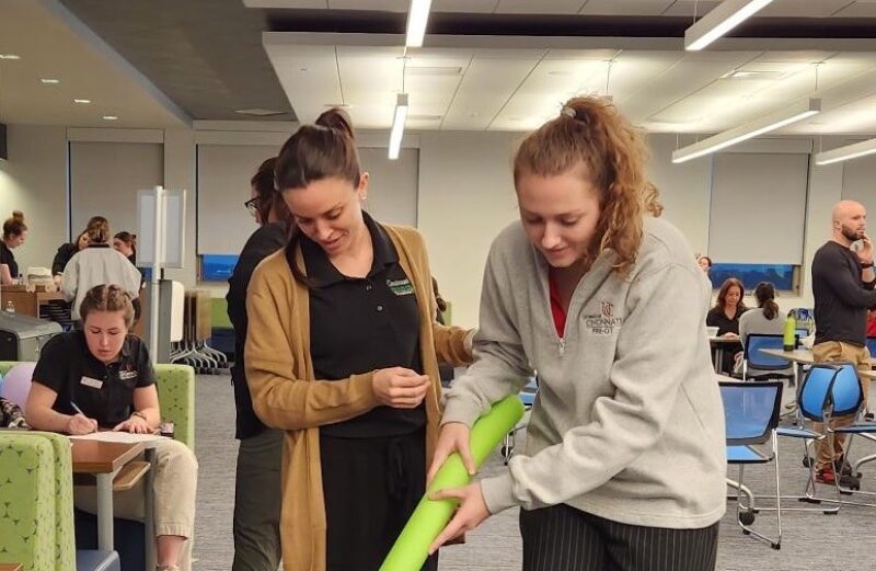 Cincinnati State Occupational Therapy Assistant student working with University of Cincinnati student