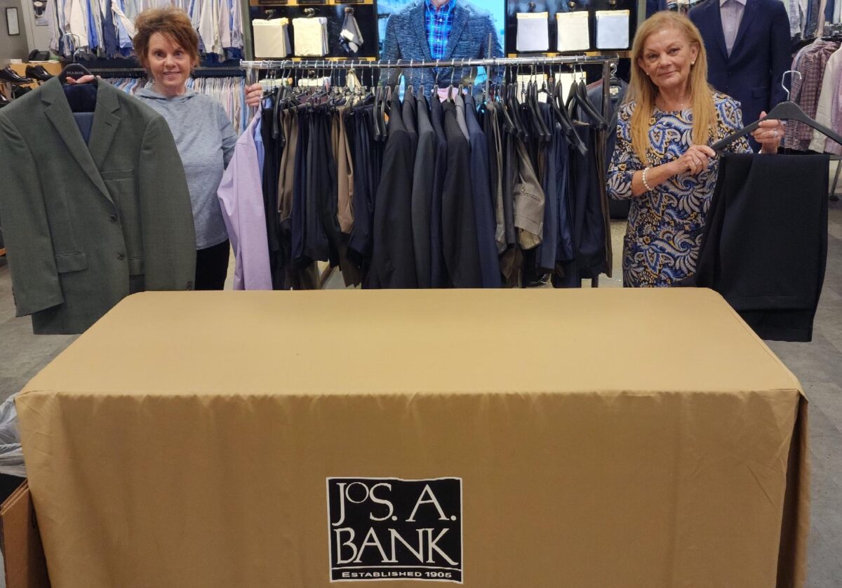 Staff from Jos. A Bank store show men's clothing items donated to Cincinnati State