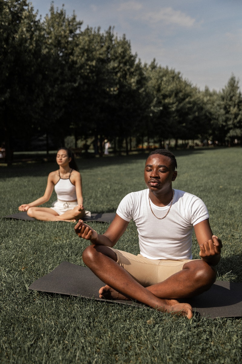 man and woman practicing yoga