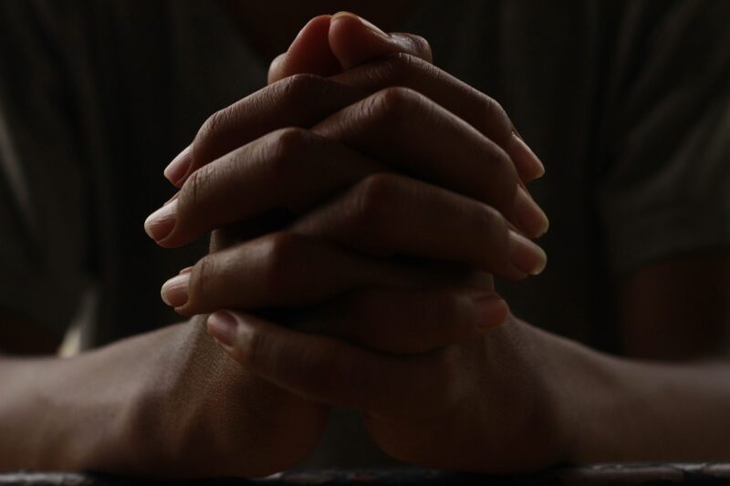 hands clasped in prayer