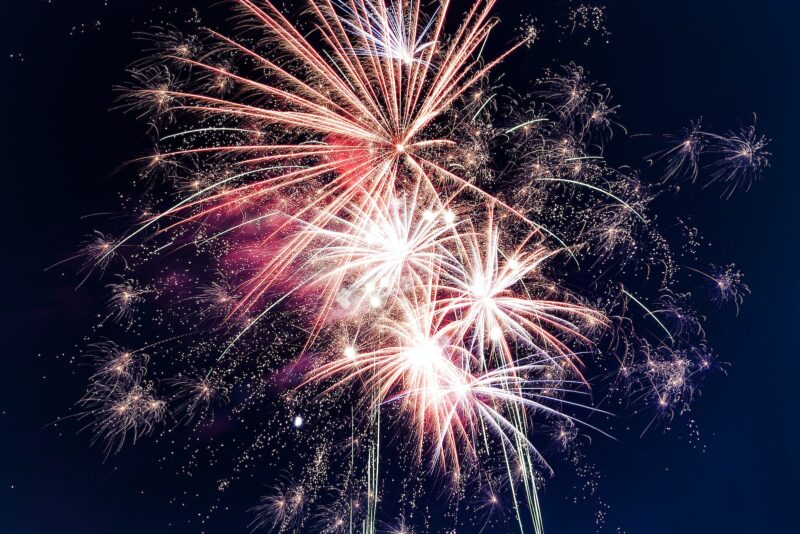 multi-colored fireworks exploding on a black background