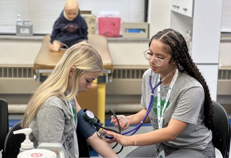 Students practicing taking blood pressure in the Cincinnati State Health Simulation Lab