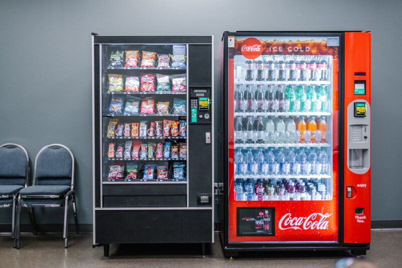 two vending machines with snacks and Coca Cola beverages