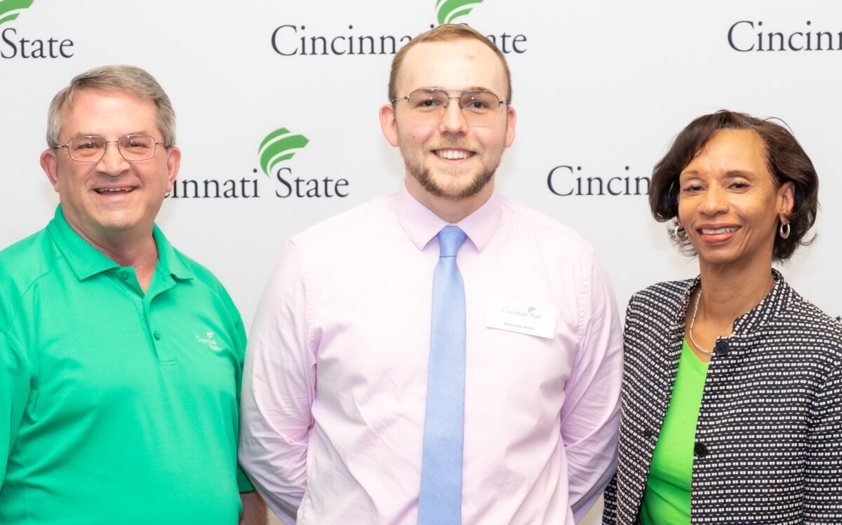 Co-op Coordinator Adam Waits, Co-op Student of the Year Alex "AJ" Hunter, and President Monica Posey