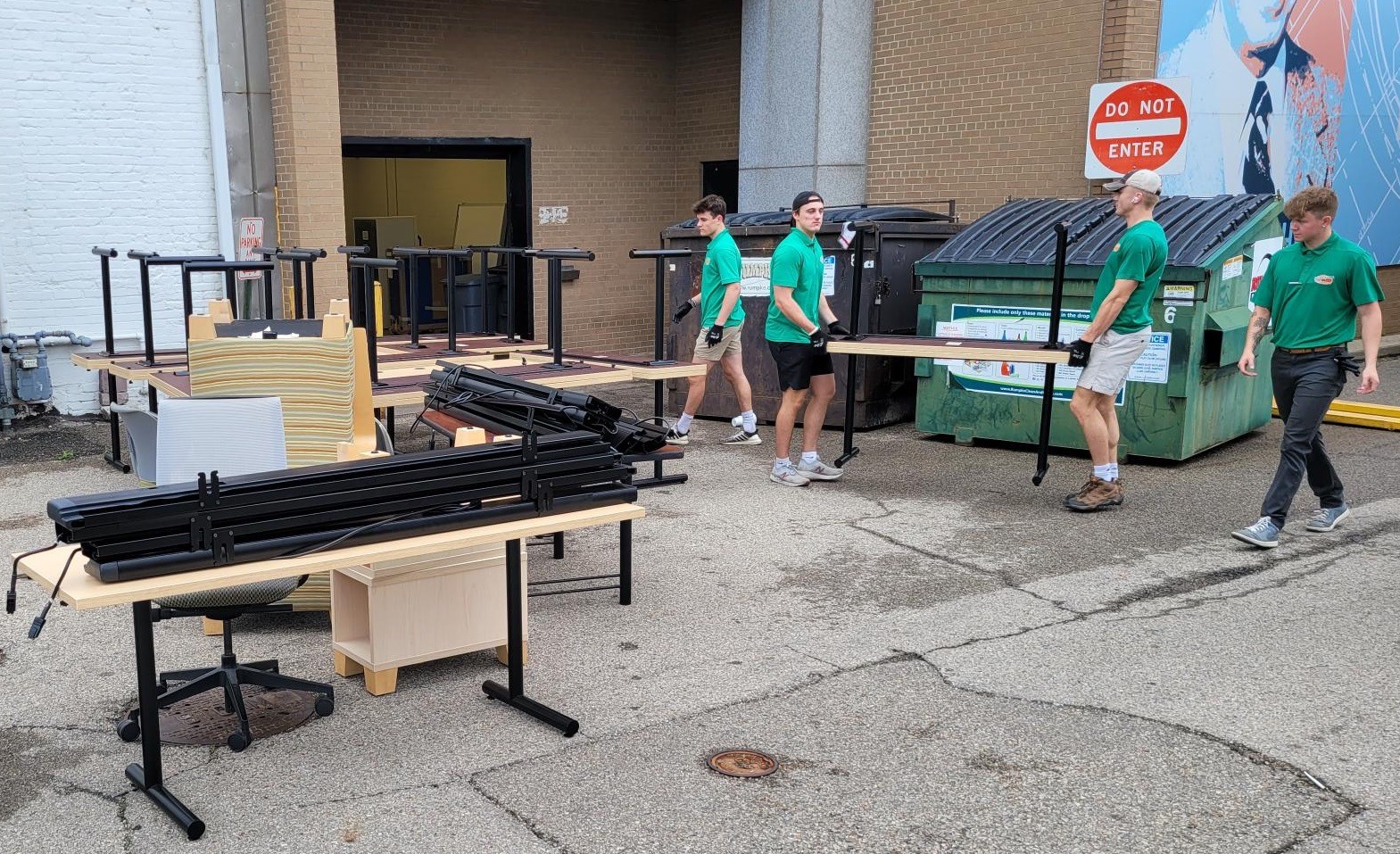 Moving crew carrying tables to the truck