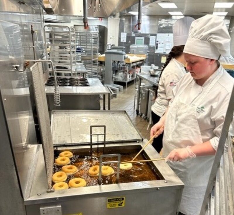 Student chef preparing donuts for National Donut Day 2023