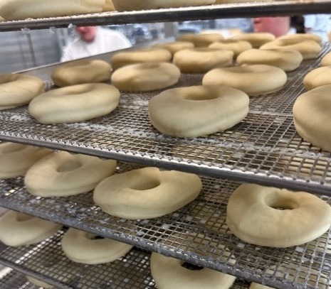 Racks of unglazed donuts