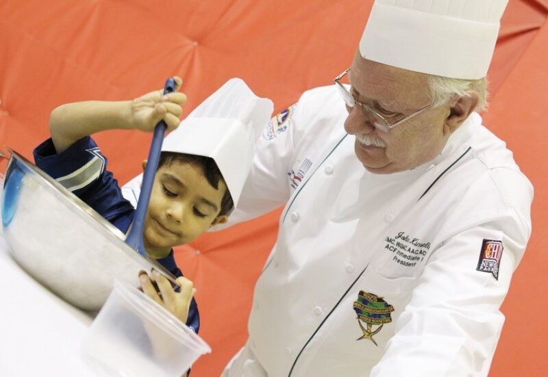 Master Chef John Kinsella supervising a child chef