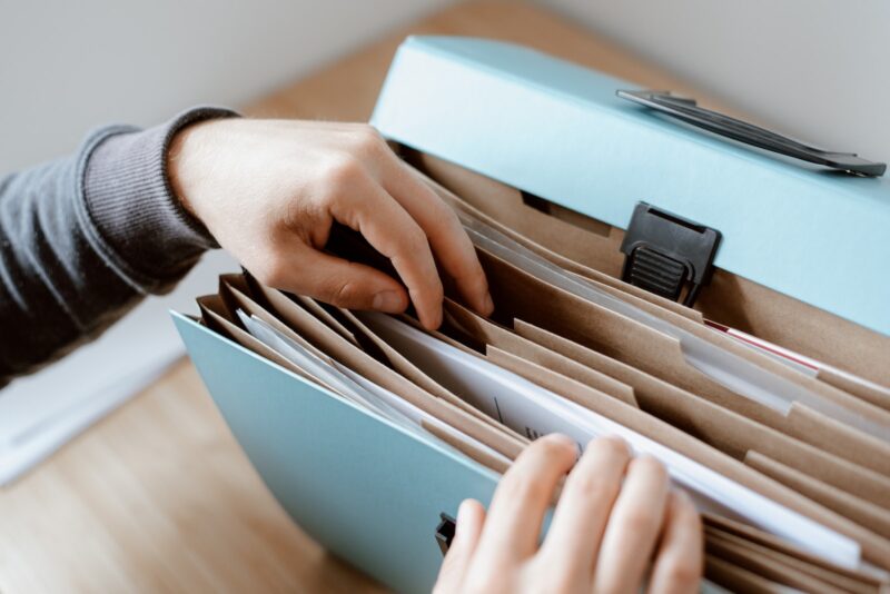 Hands of person choosing a document from a file folder