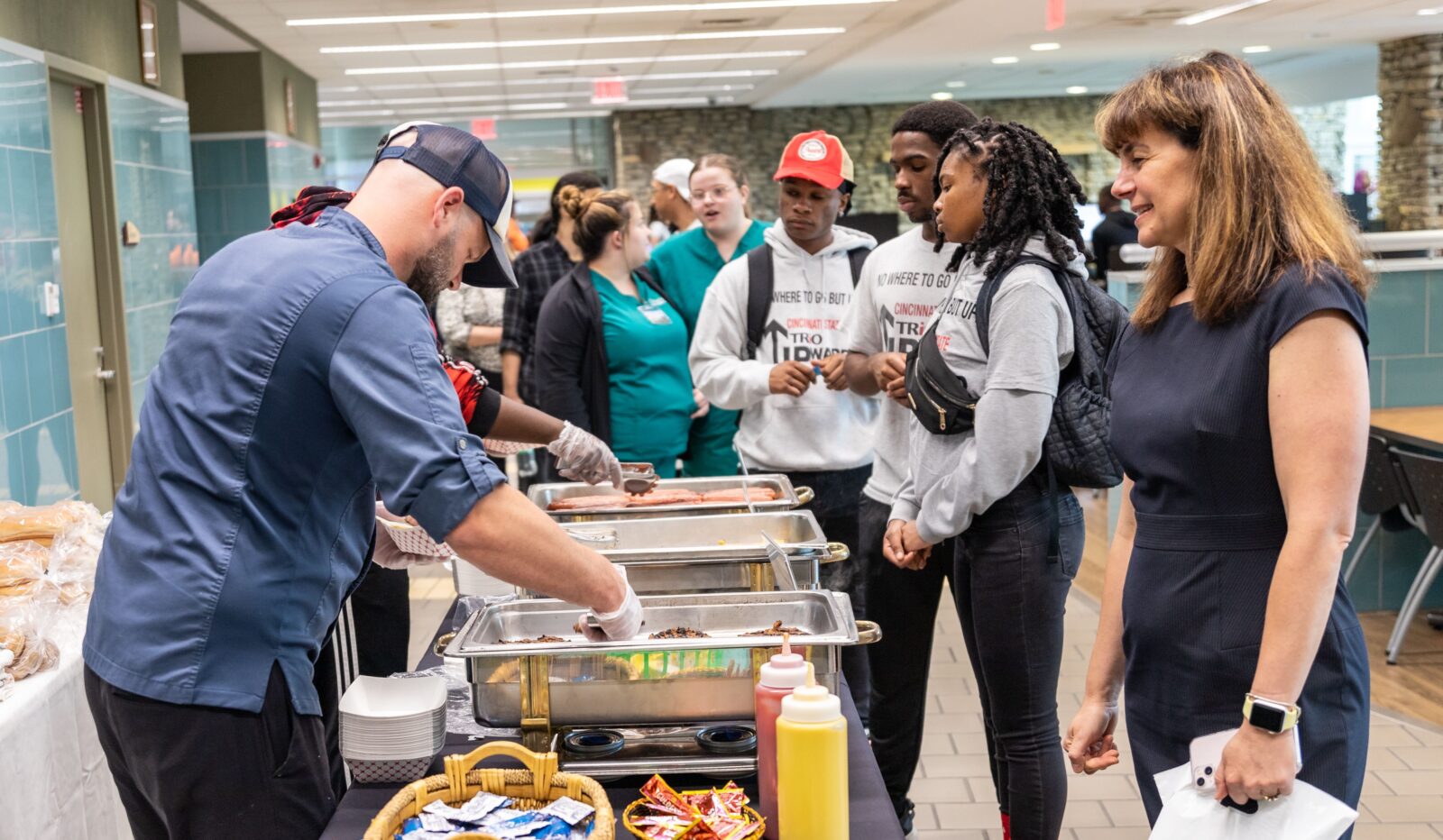 Employees and students waiting in line for lunch at the Holiday Celebration