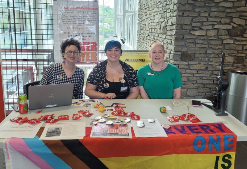 Library Specialist Margaret Breidenbaugh, Student Lune Aliff, and Testing Center Coordinator Dawn Wilke at Pride Month information table