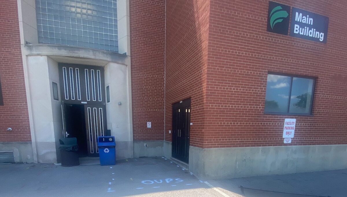 Main Building exit door 22, with white pavement markings showing area to be excavated for pipe repairs