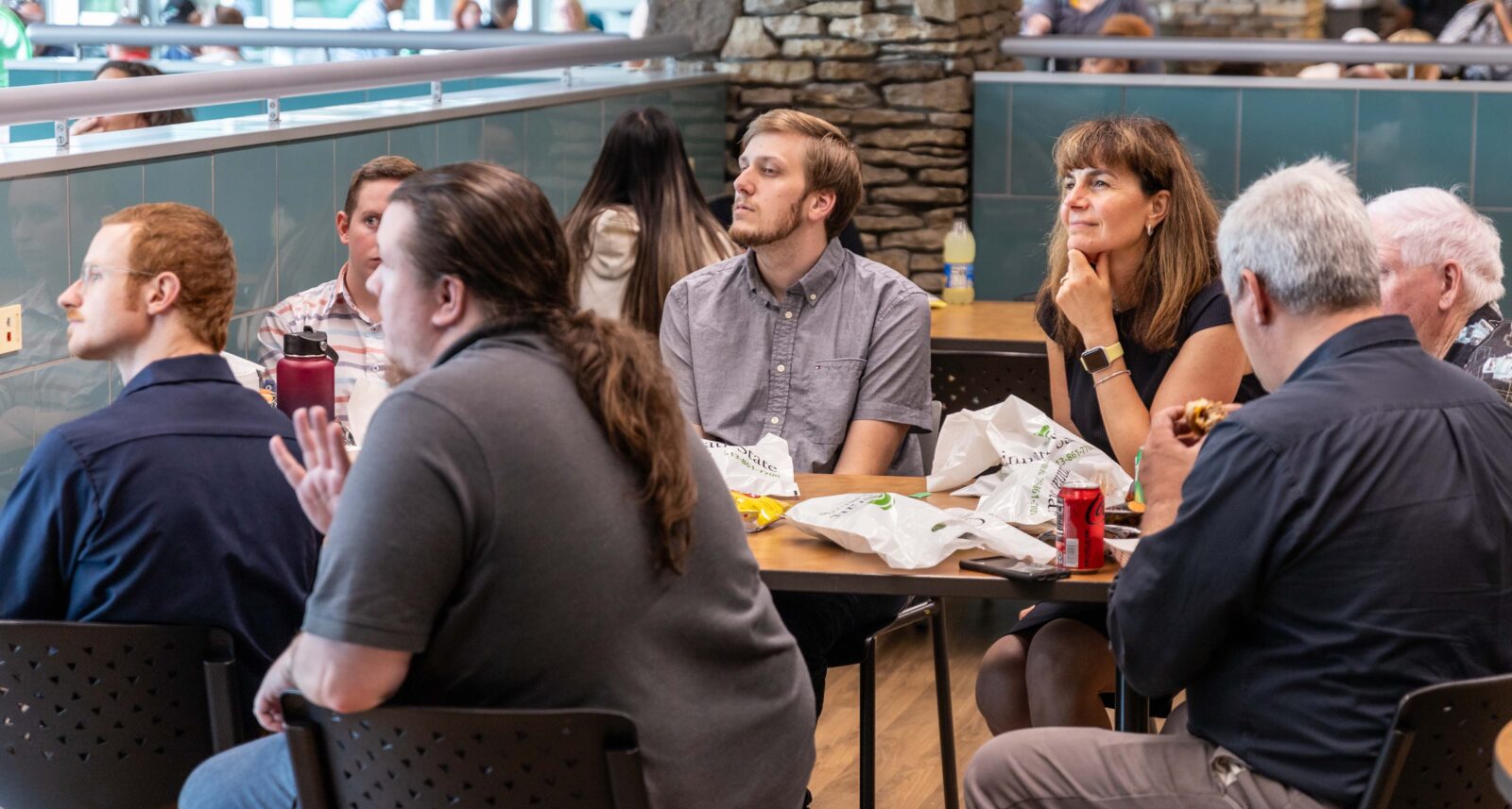 Employees listening to speakers at the Holiday Celebration