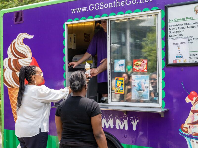 Two employees get ice cream cones at the Holiday Celebration on June 29