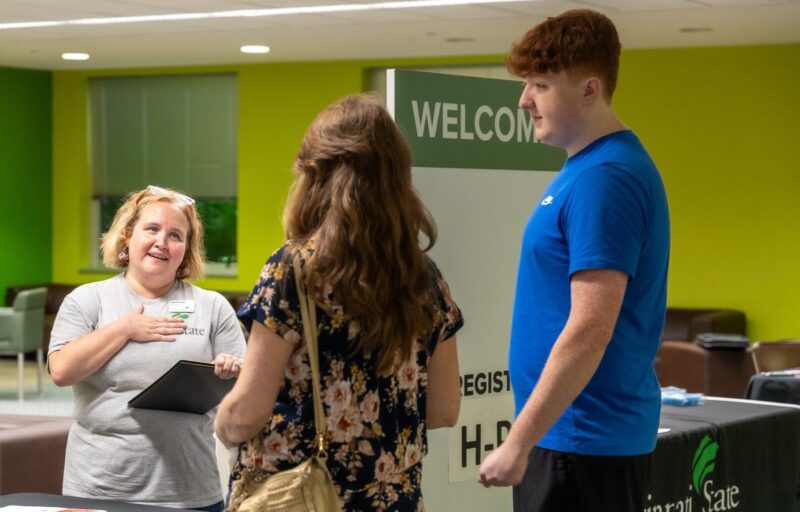 Cincinnati State staff member greets new student and parent at Welcome Day