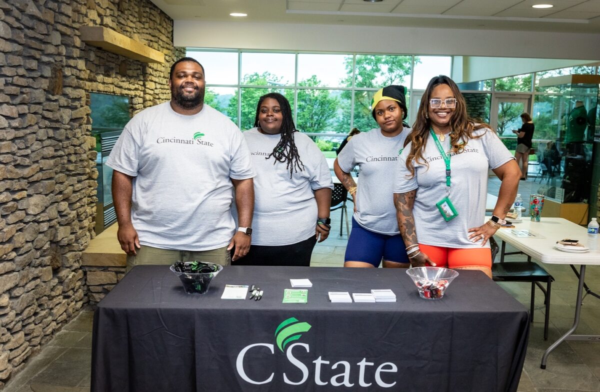 Four Cincinnati State students are smiling as they greet new students at Welcome Day