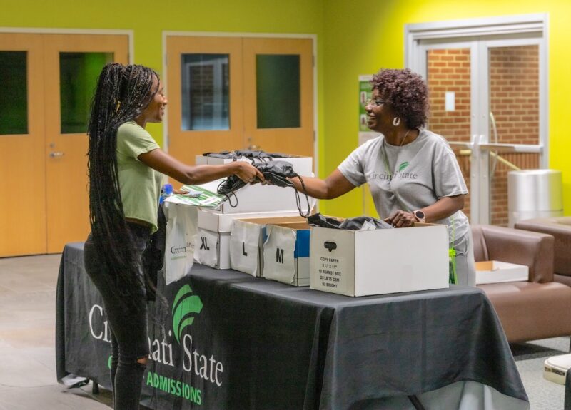 Staff member assists a new students at a summer Welcome Day event