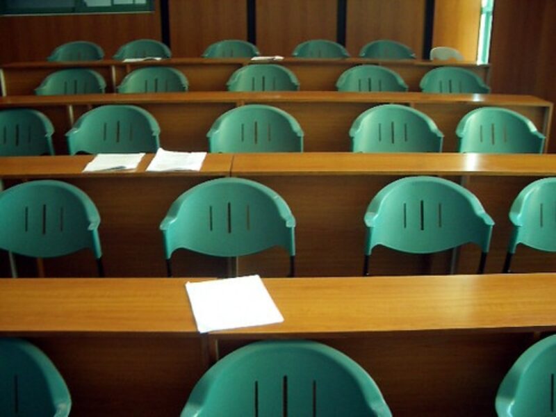 classroom with brown tables and green chairs