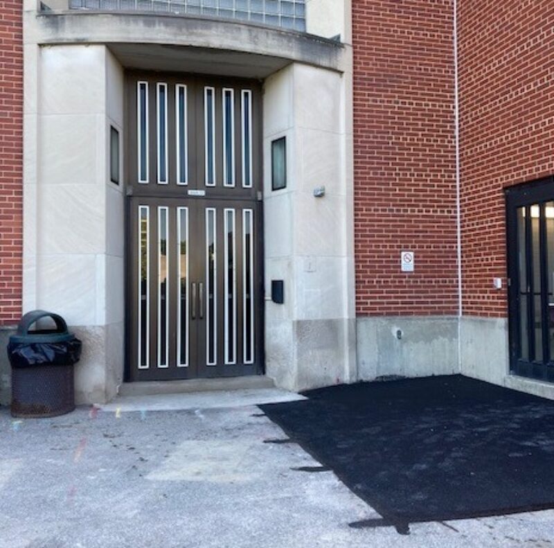 New asphalt patch outside Main Building Exit Door 22