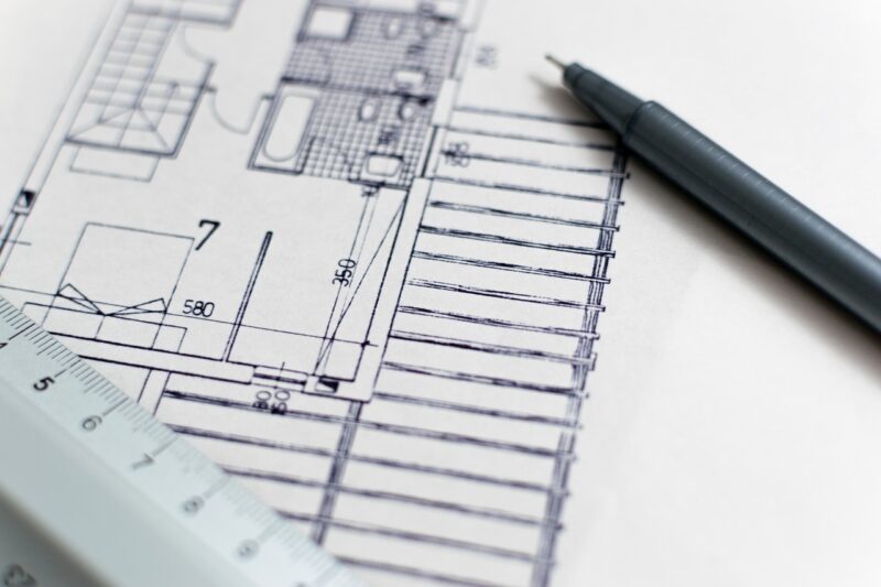 building floor plan with pen and ruler resting on the plan