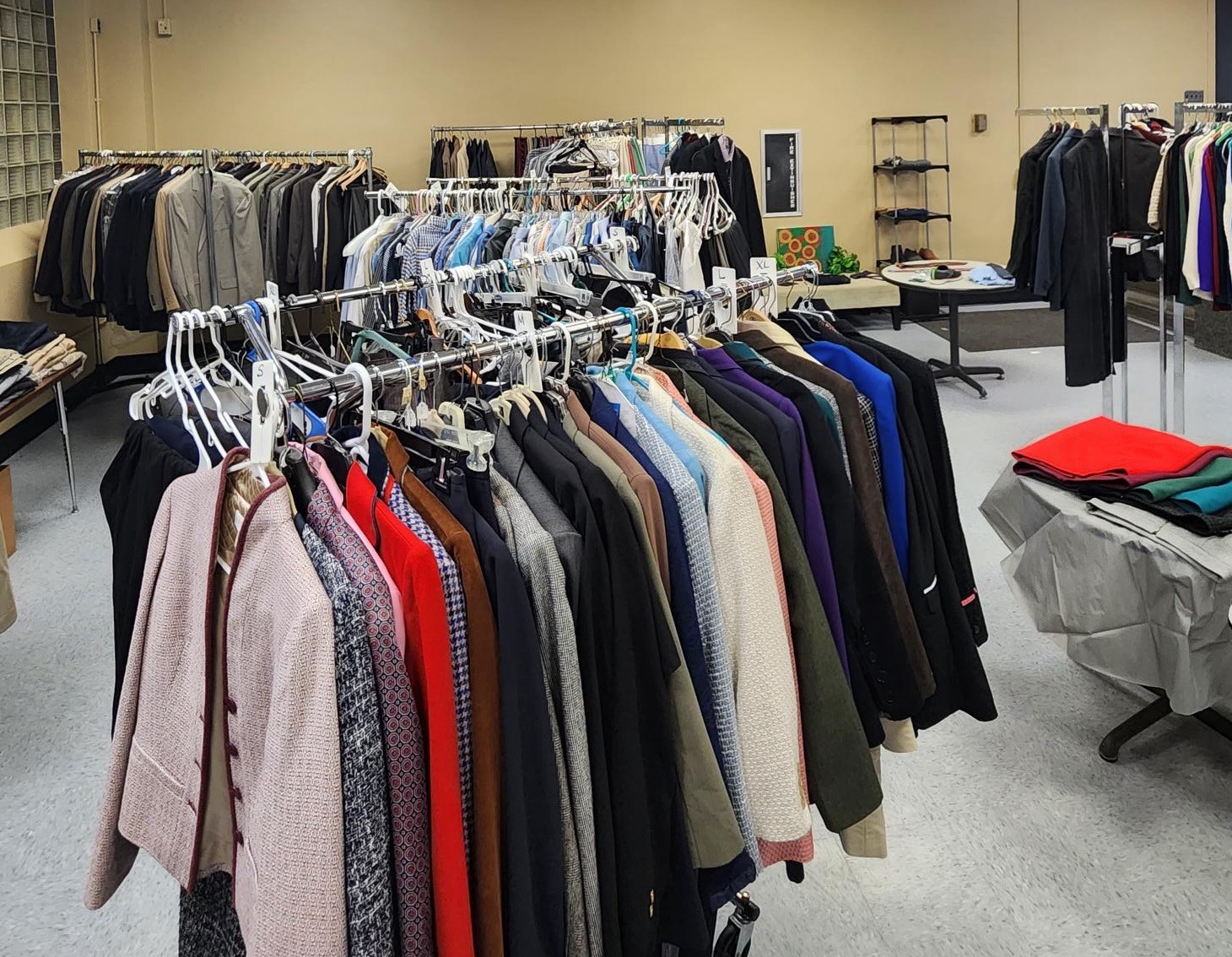 Men's and women's suits on racks at the Career Closet