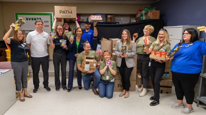 Volunteers from Kroger and Cincinnati State, along with President Monica Posey, showed off donations to the Surge Cupboard Food Pantry