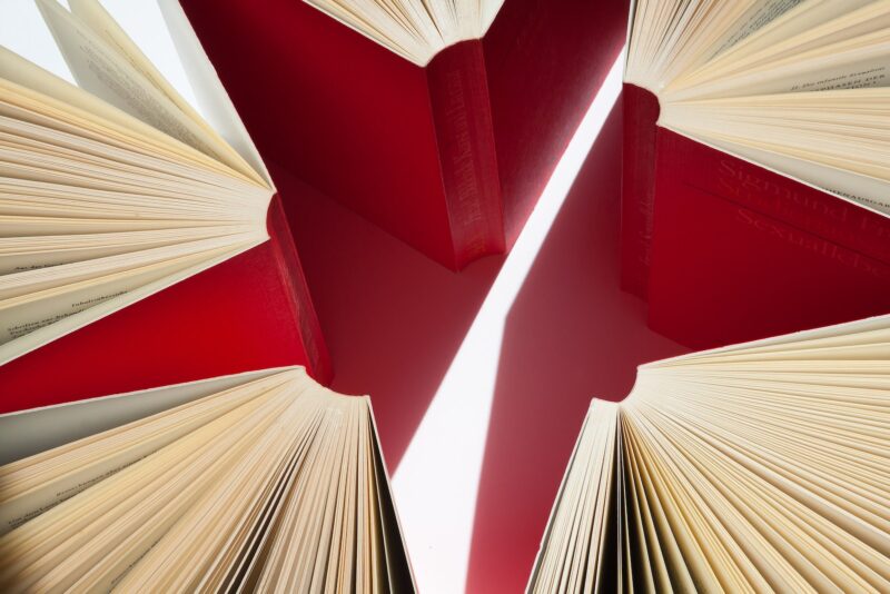Illustration of opened books forming a red star