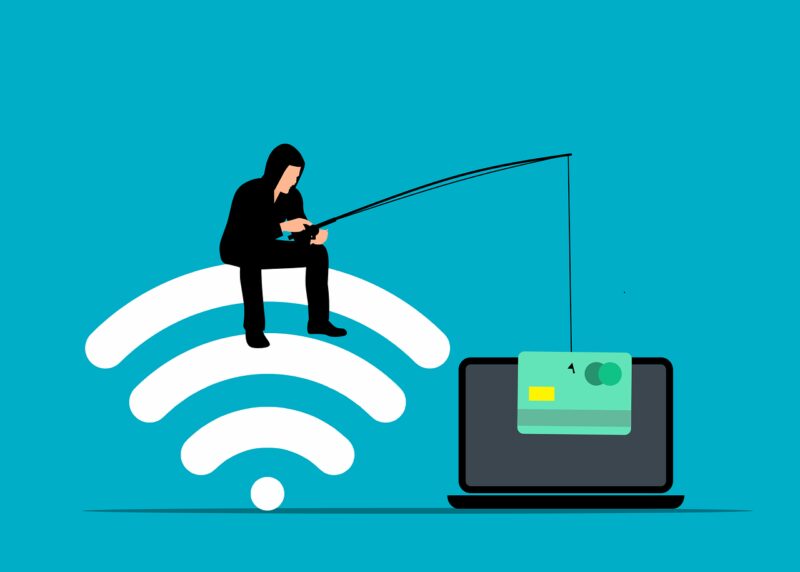 illustration of phishing-- person dressed in black is using a fishing pole to pull a credit card away from a computer screen