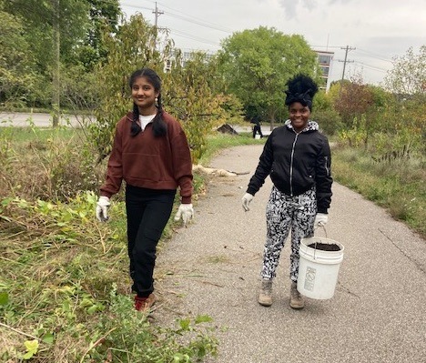 Two students clearing debris