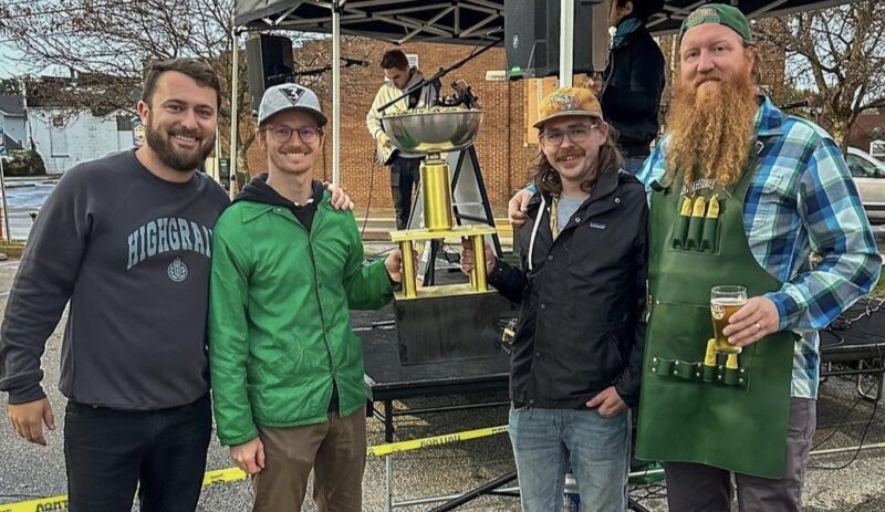 Hoisting the trophy (filled with fresh hops) are Austin Neal [HighGrain Brewery], Caleb Ochs-Naderer (Brewing Science Program Chair), Brad Brooks [Brewing Science Adjunct Instructor], and Matt Utter (HighGrain Brewery)