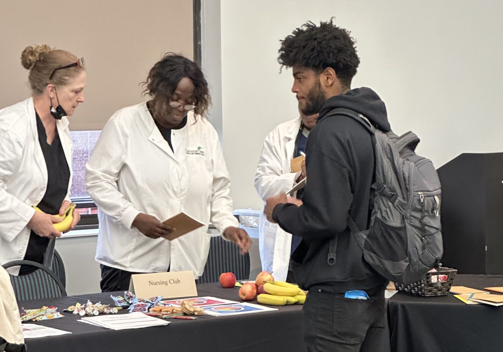 Student visits Nursing Club table at the Health & Wellness Fair 2023