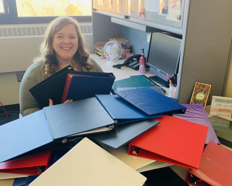 Faculty member Lauren Bregel with donated binders