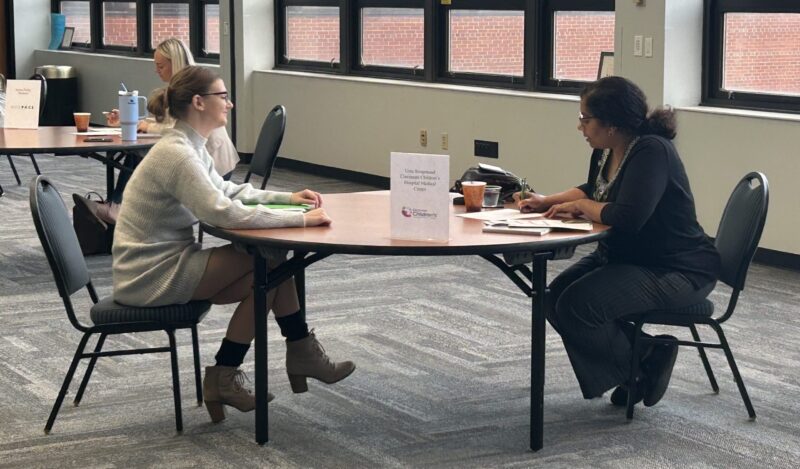 Student and interviewer sitting across from each other at a round table during Arts & Sciences Mock Interview Workshop