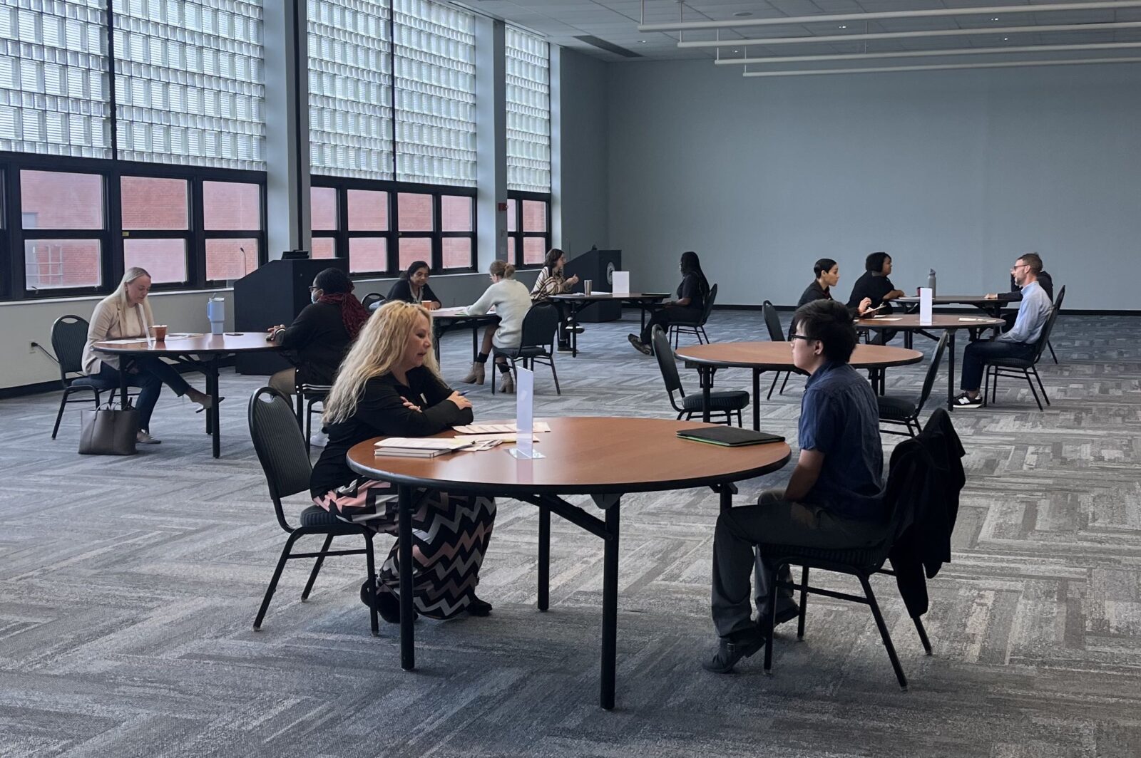 Six round tables with a student and an interviewer at each table during Arts & Sciences Mock Interview Workshop - 10-17-23