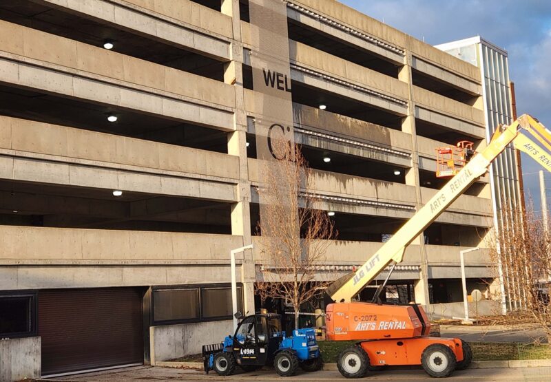 Photo of crane in use to install metal mesh 