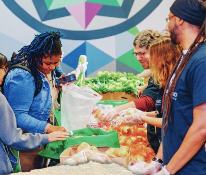 Students and volunteers distributing food at Cincinnati State Farmer's Market